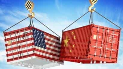 Two shipping containers, with the American and Chinese flags, crashing into each other.