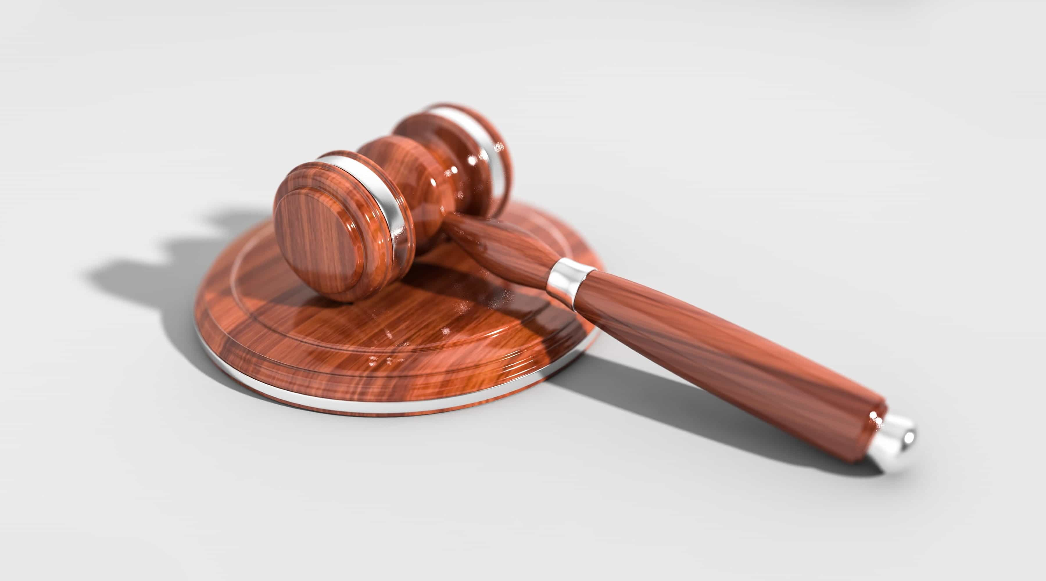 A courtroom gavel against a white background.