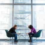 Two women working in a modern office building.