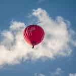 A red Virgin hot air balloon in the sky.