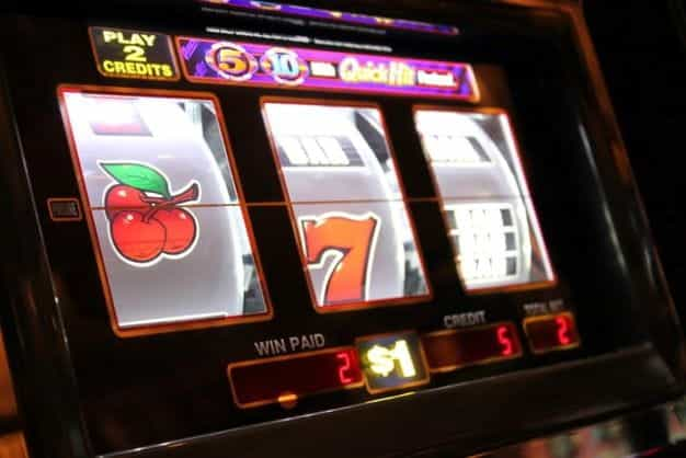 Three cherries appear on the first reel of a slot machine interface.