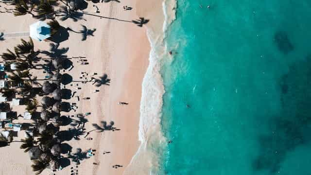 Aerial shot of the clear blue ocean beaches of Punta Cana.