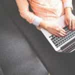 A woman using a laptop.