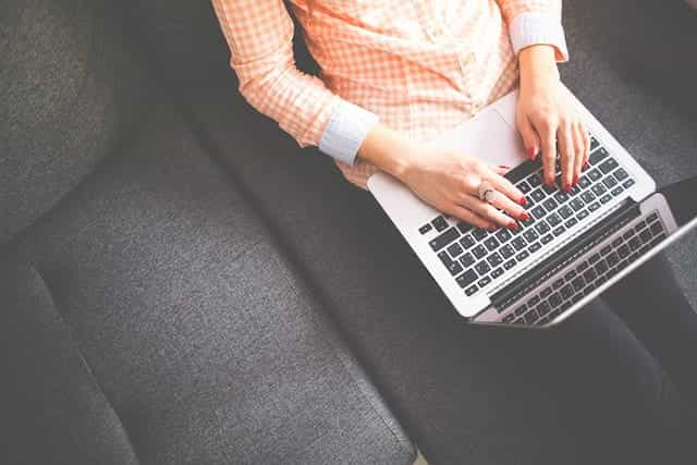 A woman using a laptop.