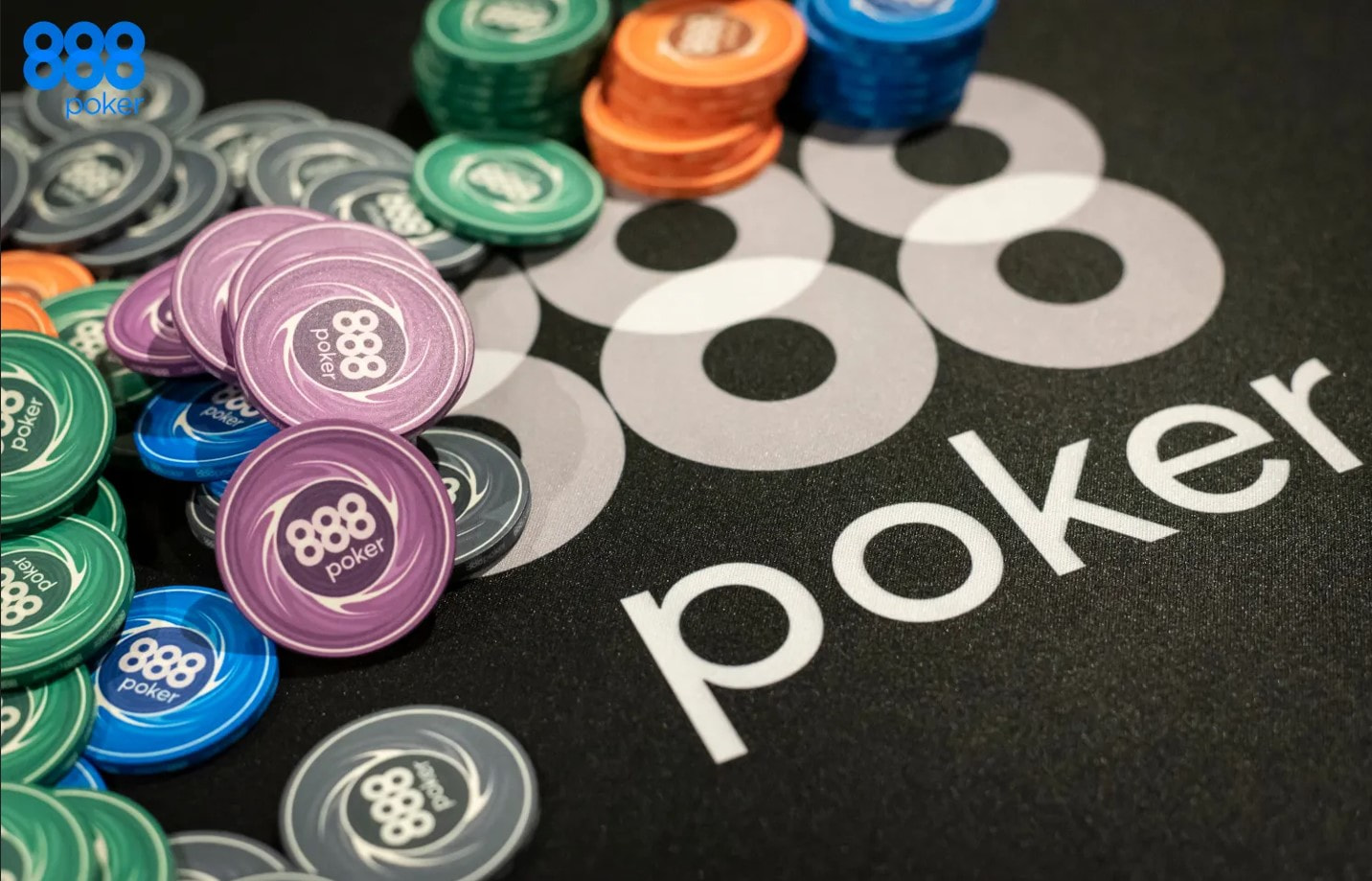 Chips and cards stacked on an 888poker branded poker table.